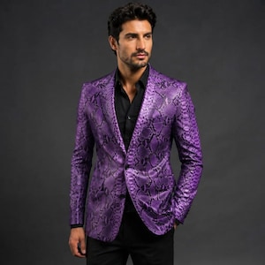 May include: A vibrant purple blazer featuring a detailed snakeskin pattern throughout the fabric. The garment includes a notched lapel, a single-button front closure, and long sleeves, worn over a solid black button-down shirt and black trousers.