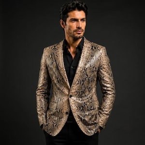 May include: A blazer featuring a tan and brown snakeskin pattern with a notched lapel, two front buttons, and two flap pockets. The garment is worn over a solid black button-down shirt, showcasing a structured fit with long sleeves and a tailored cut.