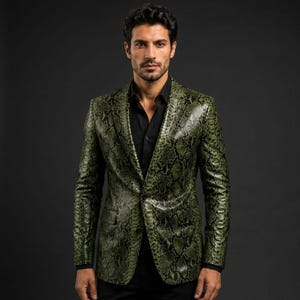 May include: A blazer featuring a green and black snakeskin pattern with a notched lapel, two front flap pockets, and a single-button closure. The garment is worn over a solid black button-down shirt with a pointed collar and long sleeves.