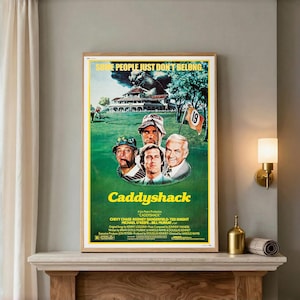 May include: A Caddyshack movie poster featuring a green golf course, a large gopher, and portraits of four actors. The text reads: SOME PEOPLE JUST DON'T BELONG, Caddyshack, and lists the cast and crew including Chevy Chase, Rodney Dangerfield, and Bill Murray.