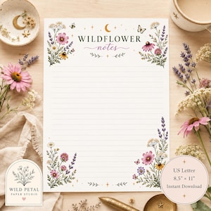 May include: A white stationery sheet with horizontal lines, featuring floral illustrations of pink, purple, and yellow wildflowers in the corners. The text reads WILDFLOWER notes. The sheet measures 8.5 inches by 11 inches, as indicated by the text.