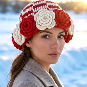 May include: A crochet hat featuring a red and white checkered pattern on the crown, adorned with a row of alternating red and cream-colored three-dimensional crocheted roses encircling the base of the hat.