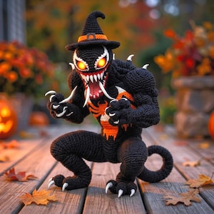 May include: A black crocheted creature figure with a pointed witch hat, glowing orange eyes, sharp white teeth, and a long tongue. The figure features a prominent orange spider emblem on its chest, muscular limbs, and white claws.