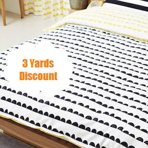 May include: A white and black patterned duvet cover with a yellow and white striped pillow and a black and white striped pillow. The duvet cover has a pattern of black half circles on a white background. The text "3 Yards Discount" is visible in the image.