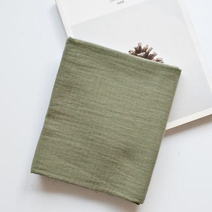 May include: A soft, green fabric swatch with a slightly textured surface.
