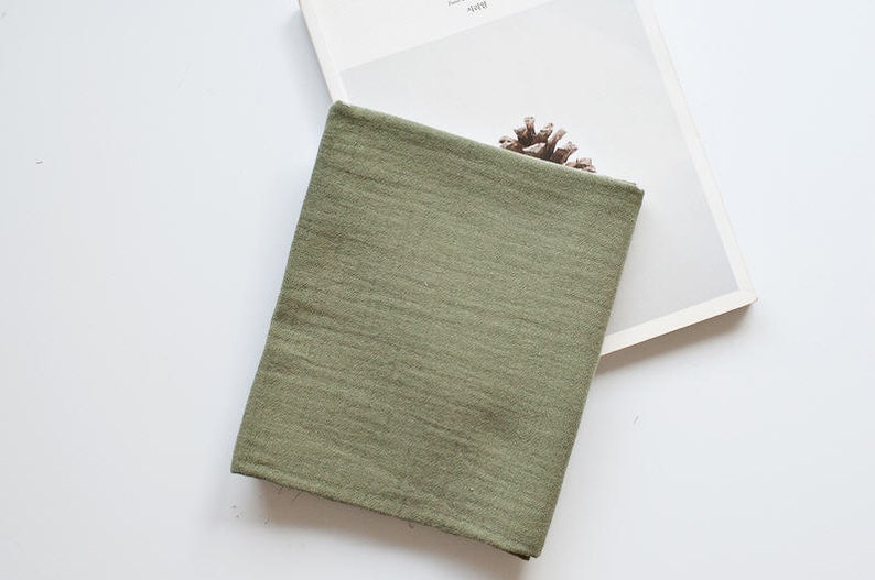 May include: A soft, green fabric swatch with a slightly textured surface.