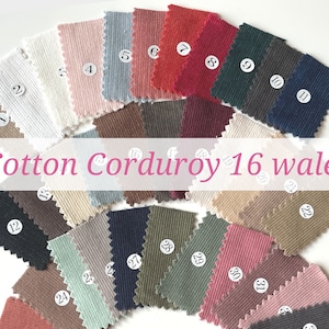 May include: A collection of 32 fabric swatches in various colours, including white, beige, brown, red, green, blue, and grey. The fabric is a cotton corduroy with a 16 wale. Each swatch is labelled with a number from 1 to 32.