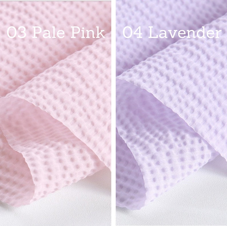 May include: Close-up of two fabric swatches. One is pale pink, the other lavender. Both have a textured, dotted pattern. Text on the left reads "03 Pale Pink" and on the right "04 Lavender".