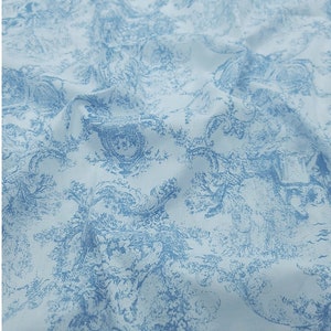 May include: A light blue fabric with a white toile pattern featuring a repeating design of trees and flowers.