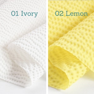 May include: Two sections of textured fabric are displayed. The left section is ivory, and the right section is lemon yellow. The text "01 Ivory" and "02 Lemon" are above the respective fabrics. The fabric has a honeycomb-like pattern.