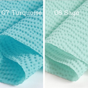 May include: Close-up of two fabric swatches. The left swatch is turquoise with the text "07 Turquoise". The right swatch is sage green with the text "08 Sage". Both fabrics have a textured, dotted pattern.