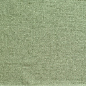 May include: A close-up of a smooth, green fabric with a subtle texture. The fabric has a slightly sheen finish.