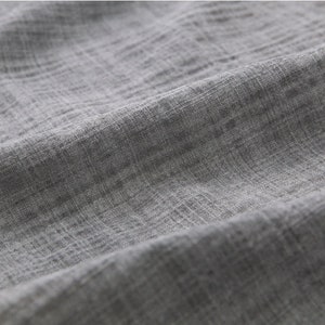 May include: Close-up of a gray textured fabric with a subtle woven pattern.
