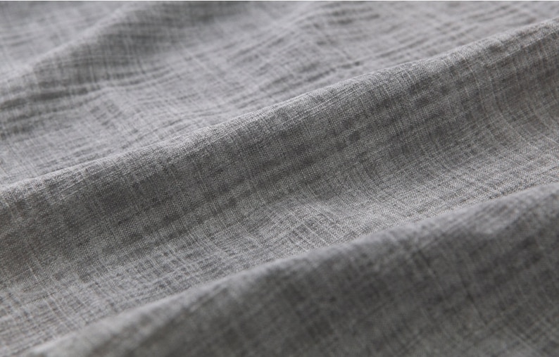 May include: Close-up of a gray textured fabric with a subtle woven pattern.