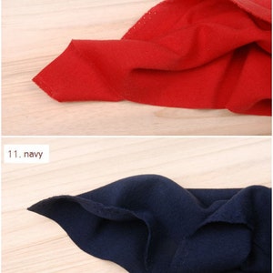 May include: Two fabric swatches, one red and one navy blue, are folded and displayed on a light wood surface. The swatches are labeled with numbers and colors: 10. red and 11. navy.