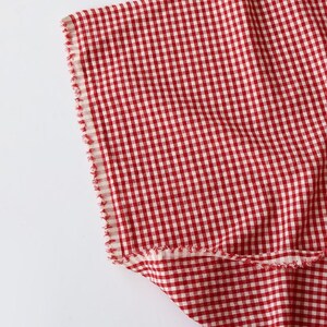 May include: A white ceramic mug with a black handle and the text "But First, Coffee" in a black, handwritten-style font. The mug is on a white surface.