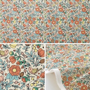 May include: A cream-colored fabric with a repeating pattern of orange, pink, and blue flowers, leaves, and birds. The fabric has a white border.