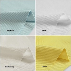 May include: Four fabric swatches in different colors: sky blue, white, white ivory, and yellow. The fabric has a ribbed texture.