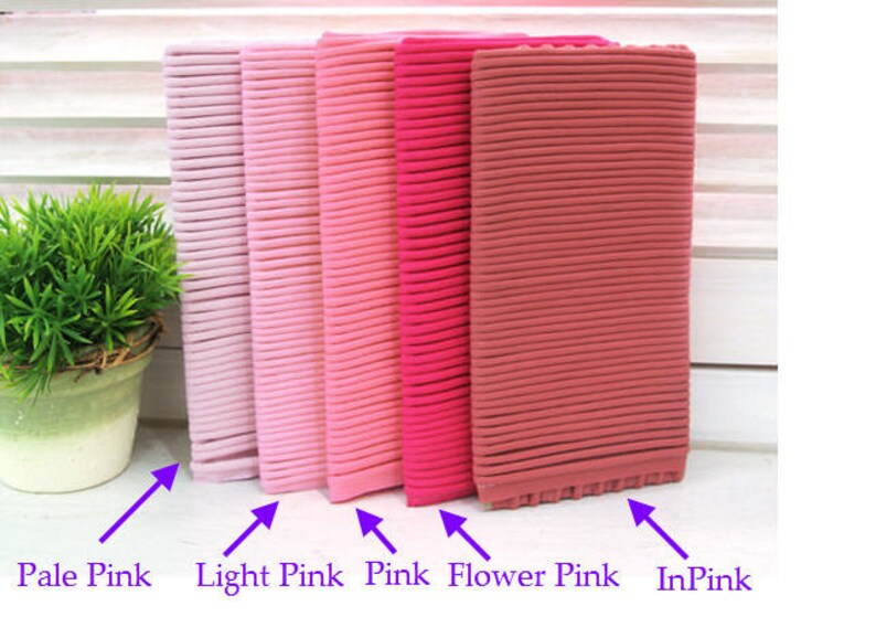May include: Five fabric swatches in different shades of pink, from pale pink to a deep pink. The swatches are labelled "Pale Pink", "Light Pink", "Pink", "Flower Pink", and "In Pink".