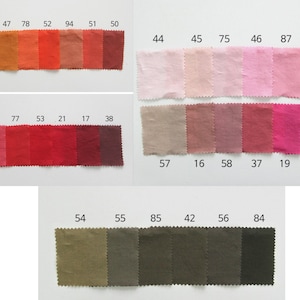 May include: A color chart with 24 fabric swatches in various shades of orange, red, pink, and brown. The swatches are numbered with corresponding numbers printed above each swatch.