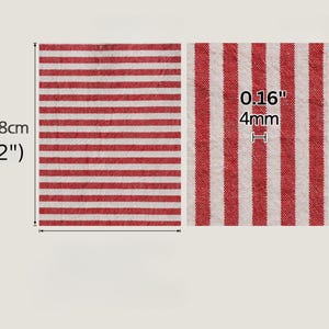 May include: A red and white striped textile, 158cm long, with a thickness of 4mm. The fabric features horizontal stripes. The image shows a close-up of the fabric's texture.