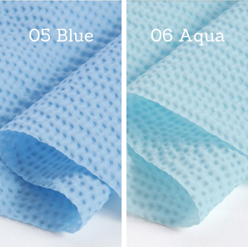 May include: Two pieces of fabric in shades of blue. The left fabric is a light blue with the text "05 Blue". The right fabric is aqua with the text "06 Aqua". Both fabrics have a textured, dotted pattern.