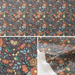 May include: A brown fabric with a repeating pattern of orange flowers, green leaves, and small birds. The fabric is folded in half, showing the pattern on both sides.