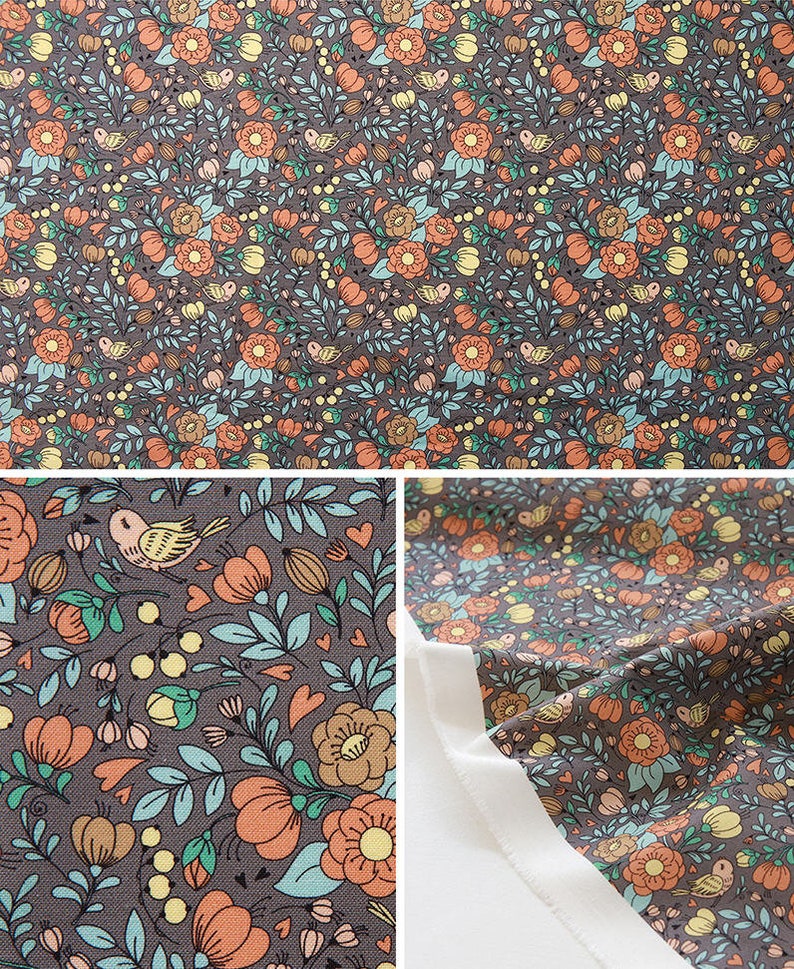 May include: A brown fabric with a repeating pattern of orange flowers, green leaves, and small birds. The fabric is folded in half, showing the pattern on both sides.