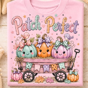 May include: A light pink t-shirt featuring a graphic of a wooden wagon filled with three smiling pumpkins wearing polka-dot bows. The text "Patch Perfect" is printed above in colorful letters, accompanied by small birds, stars, and autumn leaves.