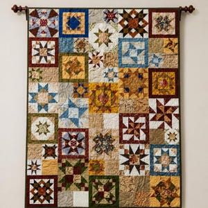 May include: A rectangular wall quilt featuring a patchwork design of various star-shaped blocks in shades of blue, yellow, brown, red, and green. The quilt is suspended from a dark brown wooden rod and displays intricate swirling machine quilting.