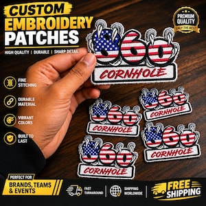 May include: Embroidered patches featuring the number 860 with the American flag pattern on the digits 8 and 6, and red and white stripes on the 0. Each digit is gripped by grey claws. The word CORNHOLE is stitched in red below the numbers.