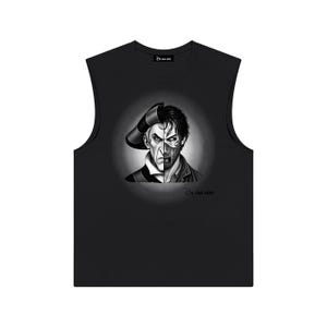 May include: A black sleeveless shirt featuring a graphic print of a split face character, with one side wearing a hat and the other side appearing as a scarred visage. The text "Be Our Vest" is printed near the neckline and below the graphic.