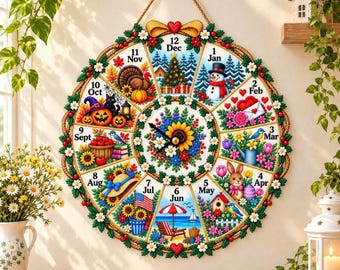 May include: A round wall clock featuring twelve pie-shaped segments, each representing a month with seasonal illustrations. The centre displays a sunflower and floral arrangement. The clock is framed by a green wreath with small white flowers.
