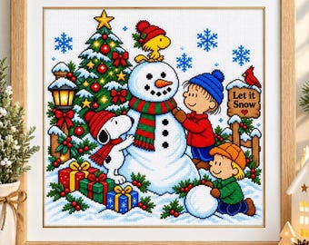 May include: A framed cross-stitch embroidery featuring Snoopy, Woodstock, and Peanuts characters building a snowman near a decorated Christmas tree. The scene includes wrapped gifts, blue snowflakes, and a wooden sign that reads Let it Snow.