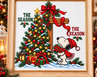 May include: A framed cross-stitch artwork featuring a decorated Christmas tree with glowing lights, a wooden cross, and a cartoon dog wearing a red hat and scarf holding poinsettias. The text reads THE SEASON THE REASON.