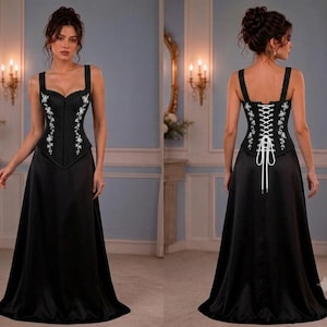 Front and back views of a model wearing a black satin dress featuring a corset bodice with white floral embroidery and lace-up back.