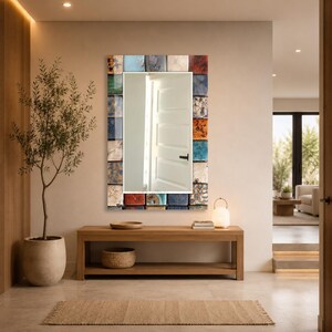 May include: A rectangular wall mirror featuring a decorative frame composed of numerous small, square tiles in a variety of colors including blue, red, orange, white, and brown, each displaying unique textures and patterns surrounding the glass.