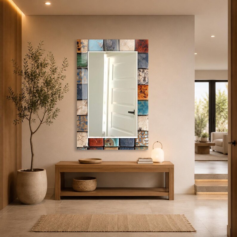 May include: A rectangular wall mirror featuring a decorative frame composed of numerous small, square tiles in a variety of colors including blue, red, orange, white, and brown, each displaying unique textures and patterns surrounding the glass.