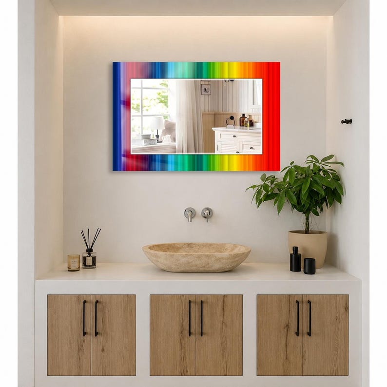 May include: A rectangular wall mirror featuring a vibrant, multi-colored rainbow border with vertical stripes in shades of red, orange, yellow, green, blue, and violet. The reflective glass surface displays a clear view of a room interior.