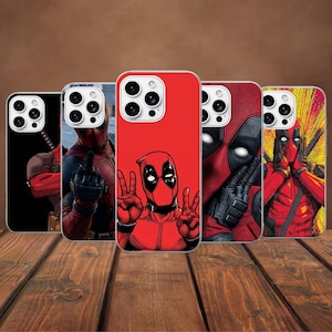 May include: Five smartphone cases featuring various illustrations of the character Deadpool in red and black suits. The designs include the character making hand gestures, posing with swords, and close-up portraits against solid red, black, or yellow backgrounds.