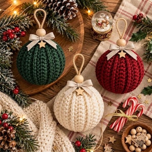 May include: Three round crochet ornaments in dark green, cream, and deep red. Each ornament features a ribbed texture, a beige ribbon bow, a small wooden star, and a natural wooden bead attached to a jute hanging loop.