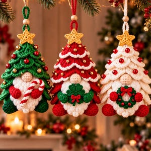 May include: Three hanging crochet gnome ornaments shaped like Christmas trees. The left gnome is green with a candy cane, the center is red with a green clover, and the right is white with a small wreath. Each has a yellow star topper.
