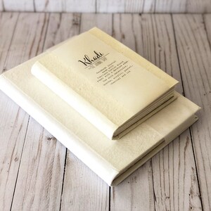 May include: Two white Khadi journals with hand-made journal paper with cotton blend, bound with a buckling edge. Use with recycled paper, pencils, pens, acrylic and ink.  Natural and chemical free.