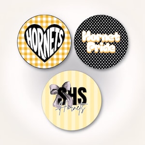 May include: Three circular stickers. The first has a yellow gingham pattern with a black heart containing the text HORNETS. The second is black with white polka dots and the text Hornet Pride. The third is light yellow with stripes, a bow, and SHS Hornets.
