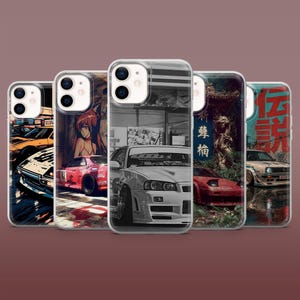 May include: Five clear phone cases featuring automotive and anime-inspired graphic designs. The cases display various sports cars, including a white Nissan Skyline, a red sports car, and a white hatchback, alongside Japanese text and urban scenes.