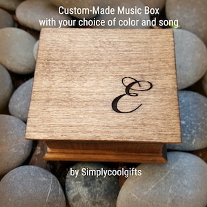 May include: Custom-made wooden music box with a personalized engraved letter "E" on the lid. The box is made by Simplycoolgifts.