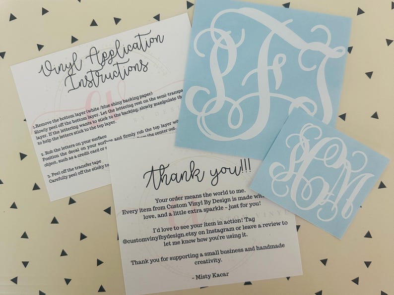 May include: A collection of custom vinyl decals in light blue with white monogram designs. Includes application instructions and a thank you card. The decals are for personalizing items.