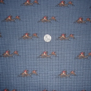 May include: Blue fabric with a repeating pattern of three riders on horses. The riders are wearing red jackets and the horses are brown.