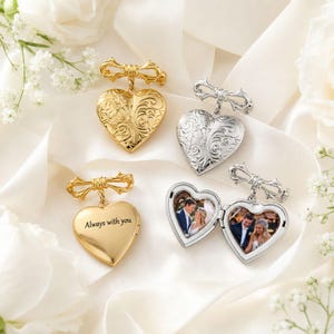 May include: Four heart-shaped lockets with bow-shaped bails. Two lockets feature intricate floral engravings, one gold-toned locket is engraved with the text Always with you, and one silver-toned locket is open, displaying two small photographs.