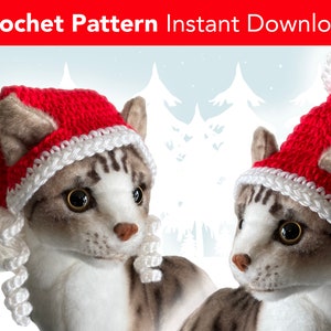 May include: Two gray tabby cats wearing red and white crocheted Santa hats. The hats have white pom-poms on top. The cats are looking to the right. The background is a snowy winter scene.